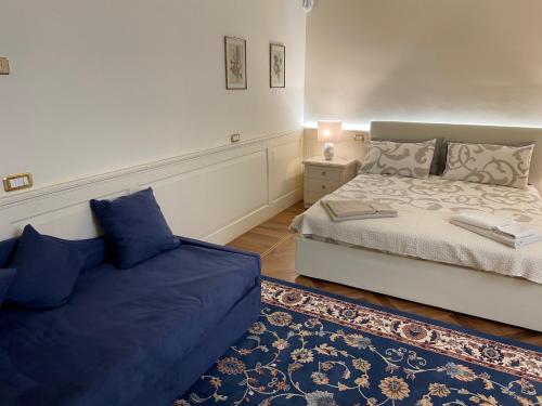 a bedroom with two beds and a rug at Relais Dei Mandorli suite centro in Bergamo