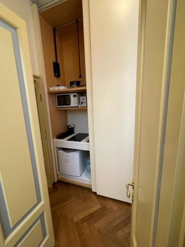 an open door to a kitchen with a microwave at Relais Dei Mandorli suite centro in Bergamo