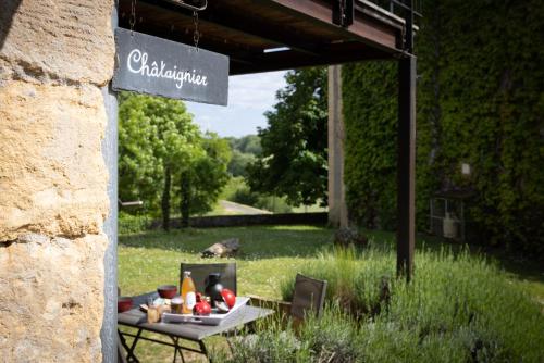 a table with food on it in a garden at Domaine Les Maurelles in Milhac