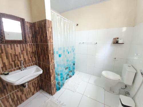 y baño con aseo y lavamanos. en Villa Residencial Encantos Da Mata, en Itacaré