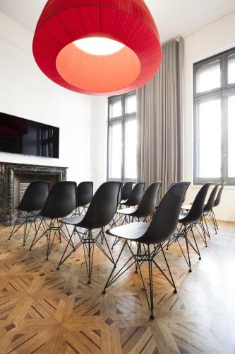 a conference room with chairs and a large red chandelier at Hotel C2 in Marseille
