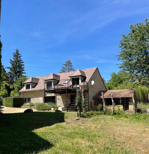 a large house with a porch and a roof at Domaine Les Maurelles in Milhac