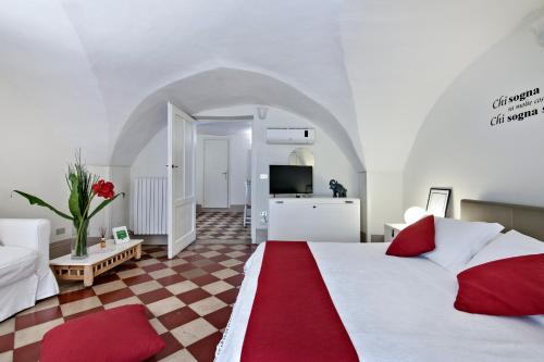 a bedroom with a large bed with a red blanket at Le Stanze Del Poeta - SIT Rooms in Lecce