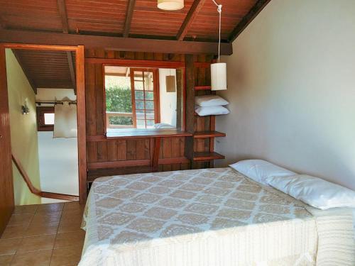 a bedroom with a bed and a window at Pousada Bangalôs Da Mole - Florianópolis in Florianópolis
