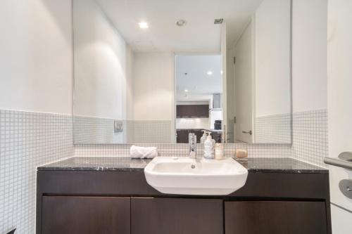 a bathroom with a sink and a mirror at Limestone House, Dubai International Financial Centre - Mint Stay in Dubai