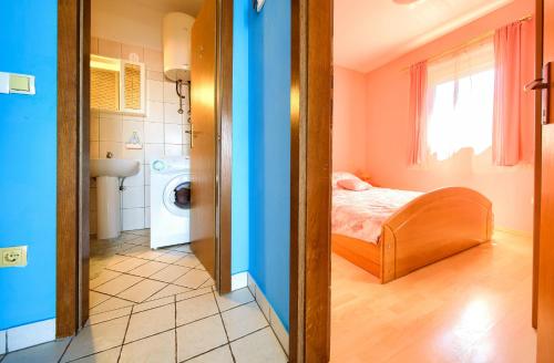a small room with a bed and a bathroom at Apartment Henrik in Krk