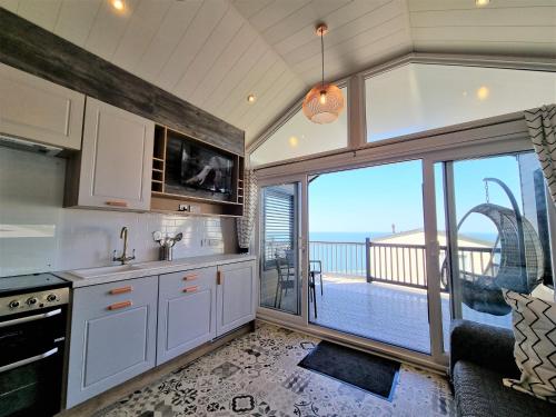 a kitchen with a view of the ocean at Sandaway Holiday Park in Combe Martin