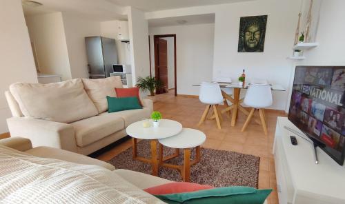 a living room with a couch and a table at Tres Islas Apartment - 70 m2 private terrace in Corralejo