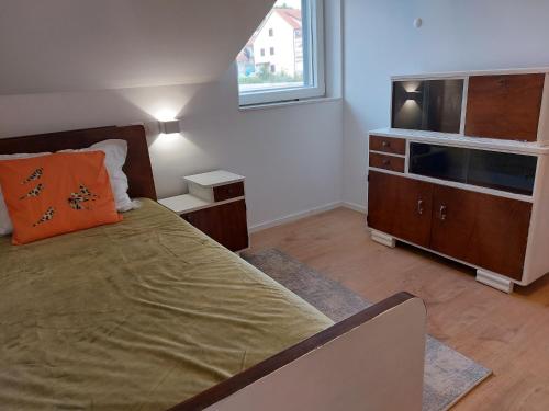 a bedroom with a bed and a flat screen tv at Apartmani Elisa in Stari Grad