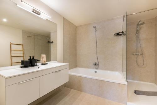 a bathroom with a tub and a sink and a shower at Jardiana Lotus - Walking distance to La Cala De Mijas in La Cala de Mijas