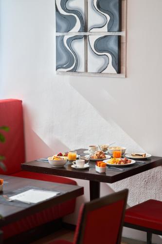 a table with plates of food on it at UNA Hotels Malpensa in Cerro Maggiore