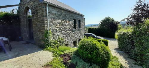 a brick building with bushes in front of it at B&B Domaine du Vieux Chêne in Stoumont