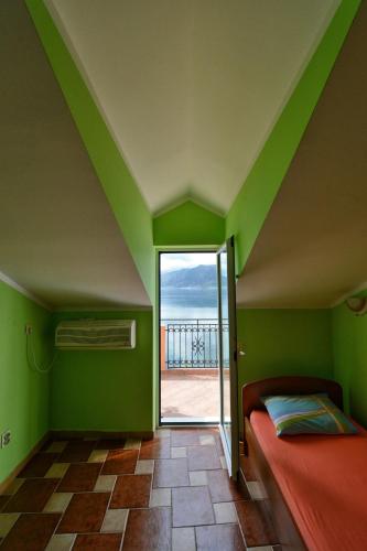 a room with a room with a bed and a window at Apartments Goran in Kotor