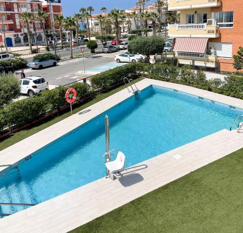 a swimming pool with a chair next to a building at Sealine Vidorra in Torrox Costa