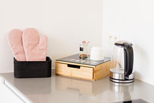 a counter top with a coffee maker and a blender at Luxury Suites South by Rikas Hotels in Antwerp