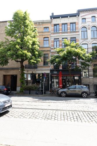 a city street with cars parked in front of buildings at Luxury Suites South by Rikas Hotels in Antwerp