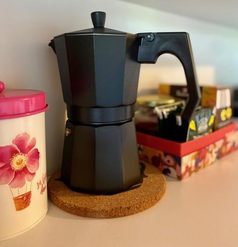 a coffee maker sitting on a counter next to a container at Lucky Home - Apartment Art Grožnjan in Grožnjan