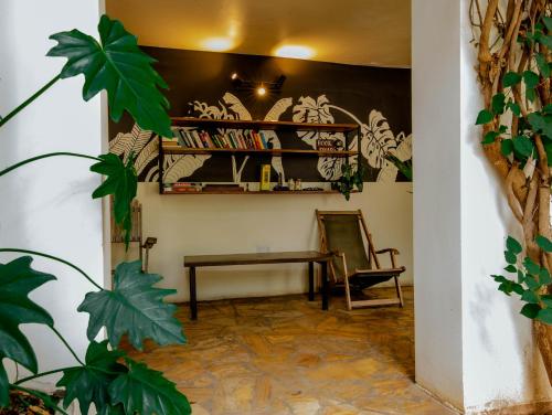 a living room with a table and a chair at The Slow Leopard in Dar es Salaam