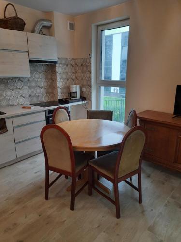 a kitchen with a wooden table and chairs in a kitchen at U Anny in Wałcz