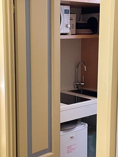 a cupboard with a sink and a sink at Relais Dei Mandorli suite centro in Bergamo