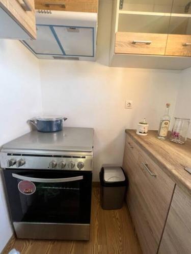 a kitchen with a stove and a trash can at #5 Beach Villa Lipsi Island Getaway in Lipsoi