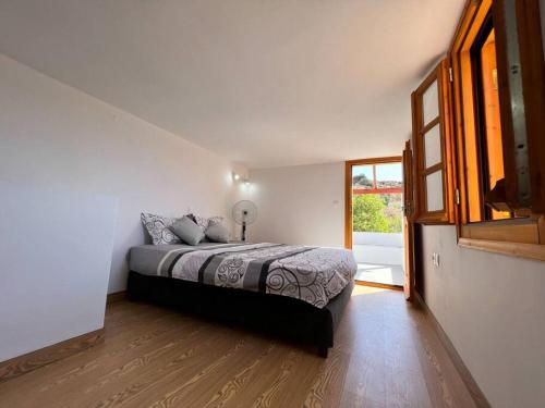a bedroom with a bed and a large window at Beach Villa Lipsi Island Getaway in Lipsoi