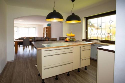 a kitchen with a large island in a room at Villa am Wehr in Allersberg