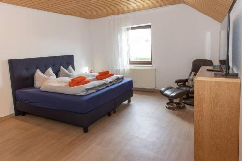 a bedroom with a bed with orange pillows on it at Villa am Wehr in Allersberg