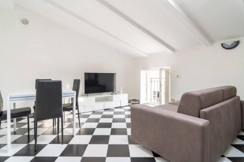 a living room with a couch and a table at Chess House in Azzano Mella