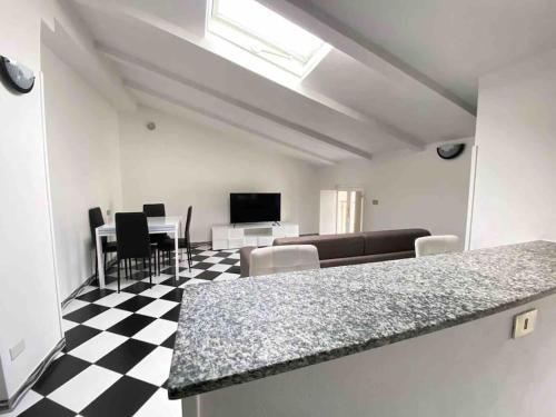 a living room with a black and white checkered floor at Chess House in Azzano Mella