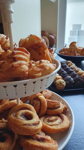 a pile of pastries on a white plate on a table at Uferdeck - Boutique Hotel in Traben-Trarbach