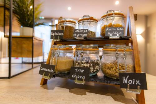 a display of jars of food on a shelf in a store at ibis Besançon Centre la City in Besançon