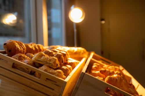 two boxes of donuts sitting on top of a table at ibis Besançon Centre la City in Besançon