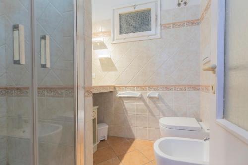 a bathroom with a shower and a toilet at La Corte by HelloElba in Portoferraio