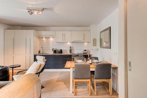 une cuisine et une salle à manger avec une table et des chaises dans l'établissement APARTMENT COSMIQUES - Alpes Travel - Central Chamonix - Sleeps 4, à Chamonix-Mont-Blanc