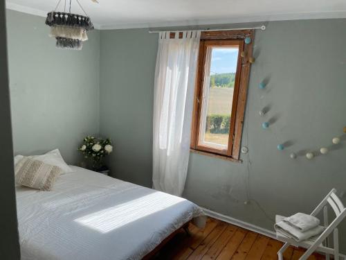 a bedroom with a bed and a window at Katrina Summer House in Jūrmalciems