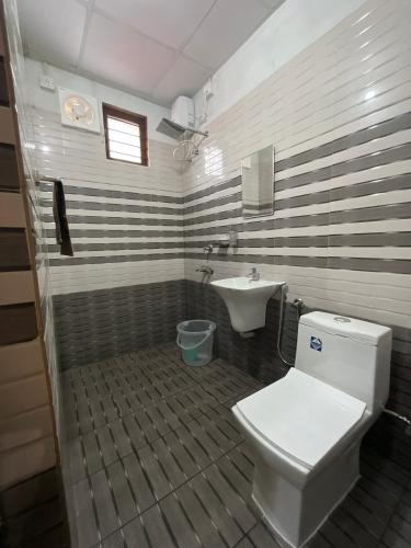 a bathroom with a toilet and a sink at Vrindavan homestay in Munroe Island