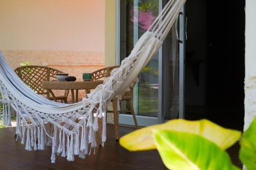 a hammock in a room with a view of the beach at Ocean Vibes in Thongsala