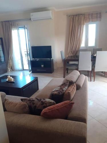a living room with a couch with pillows on it at SIMOS' sea view house in Nikópolis