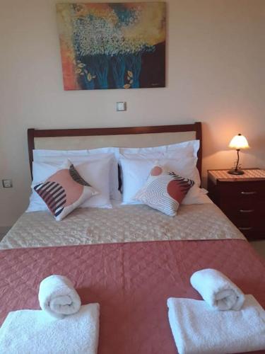 a bedroom with a bed with towels on it at SIMOS' sea view house in Nikópolis