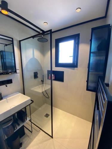 a bathroom with a shower and a sink at Le Mazet des maisons du golf in Sainte-Maxime