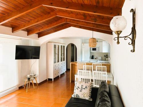 a living room with a couch and a kitchen at Private Apartments Cala Canyelles in Lloret de Mar