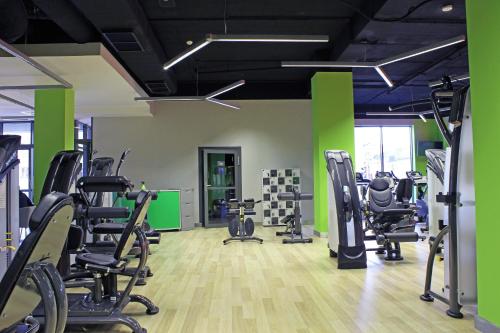a gym with several treadmills and exercise bikes at Hotel Great Polonia Velvet Suwałki in Suwałki