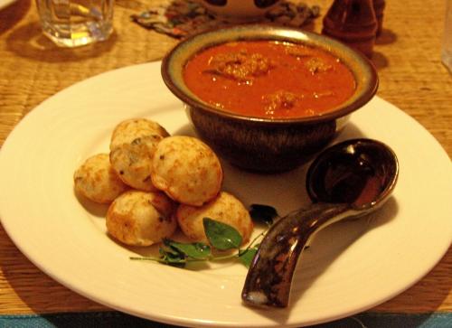 a plate of food with a bowl of soup and dumplings at Maison Perumal Pondicherry - A CGH Earth Experience in Puducherry