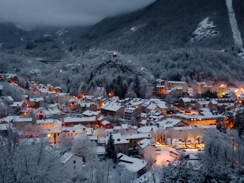 a small town covered in snow at night at les gites axéens (l'Ours) in Ax-les-Thermes