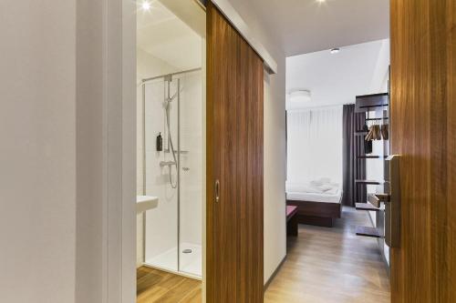 a bathroom with a walk in shower next to a door at Hotel Rhönkitz in Bad Kissingen