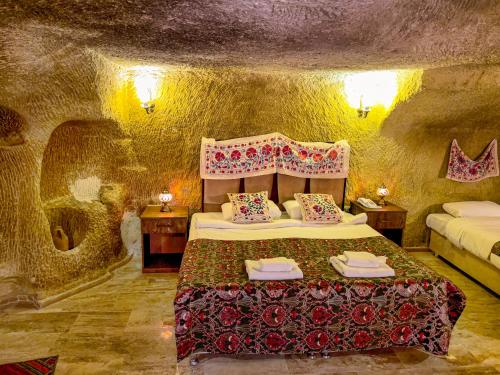 a bedroom with a bed in a stone room at Heritage Cave Suites in Ürgüp