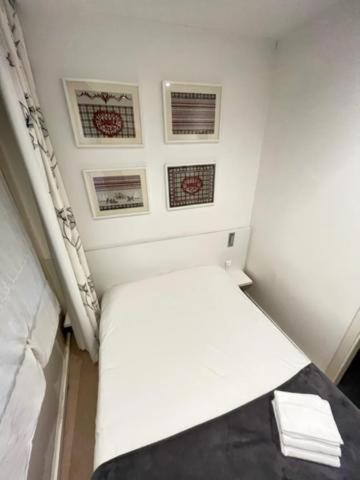 a small room with a white bed in a room at Residence OLit Cathédrale in Strasbourg