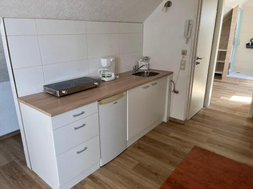 a small kitchen with a counter and a sink at Apartment Topp adult only in Wangerland