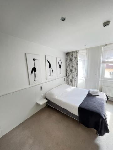 a bedroom with a bed with three birds on the wall at Residence OLit Cathédrale in Strasbourg